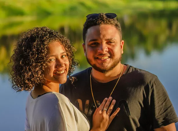 A man and woman smile warmly at the camera