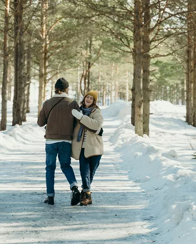 A man and woman walking together through a serene