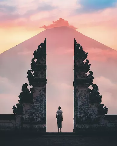 A man stands before an archway