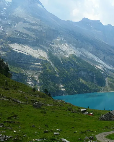 A serene mountain landscape with a clear blue lake reflecting the peaks