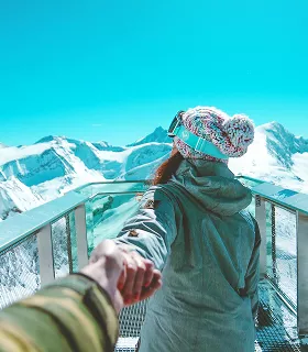 Majestic white building with a golden dome, reflected in a rain-soaked pavement